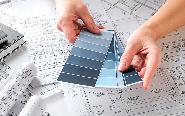 Designer selecting powder coating for a project from a color scale