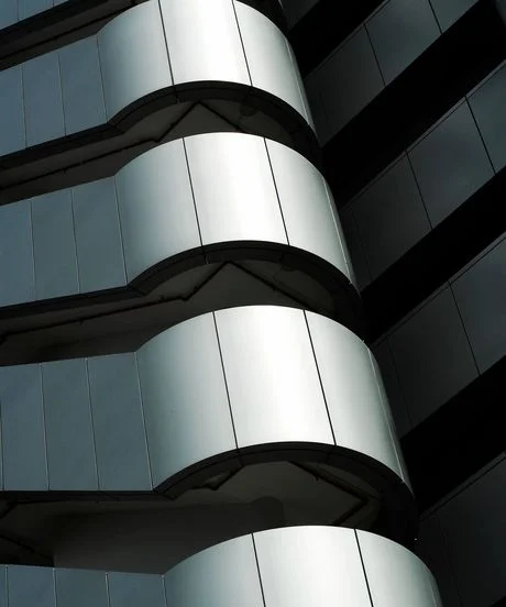 round corner of a buildings facade coated in anodized silver