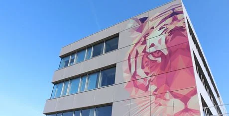Wall of the TIGER headquarters building in Austria showing a tiger printed onto the right of the facade