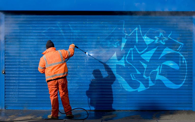 Guy cleaning graffiti