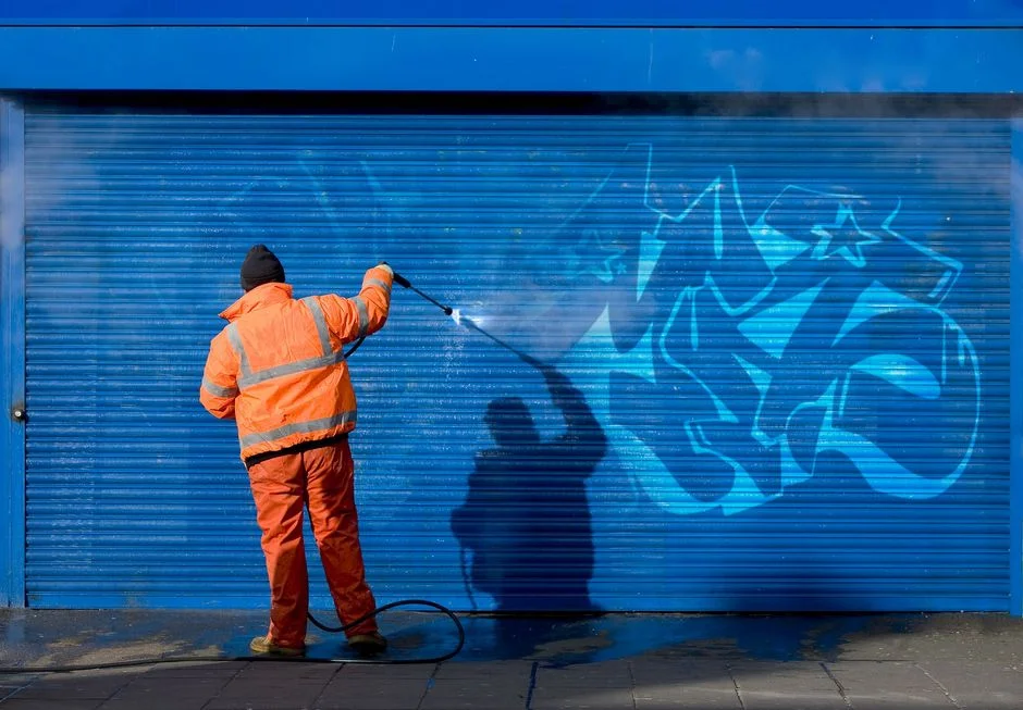 Guy cleaning graffiti