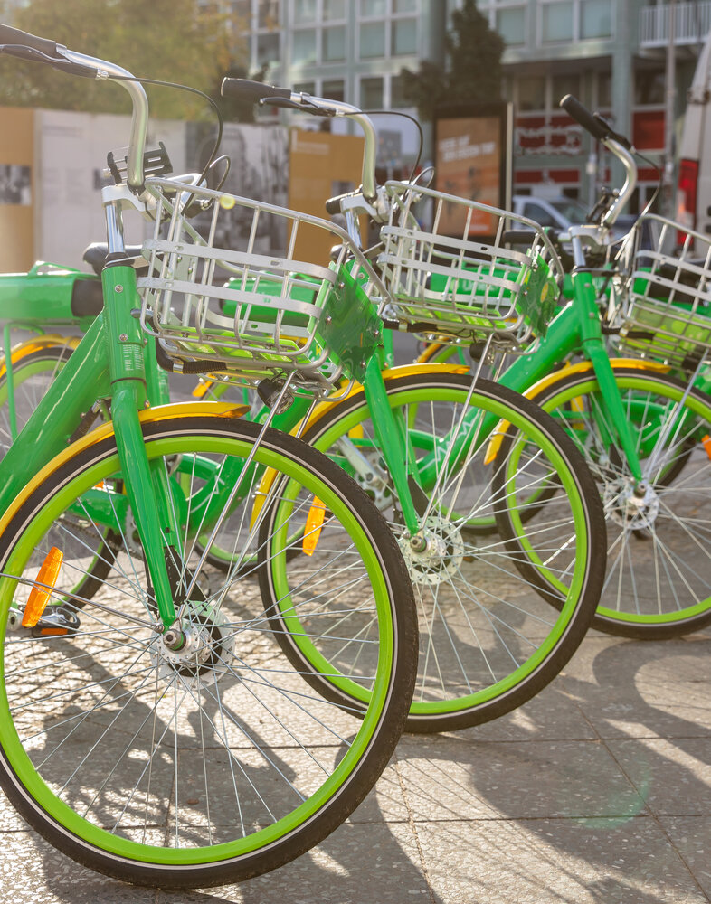 green-bikes-with-baskets-parked-on-a-cobblestone-Envato.jpg