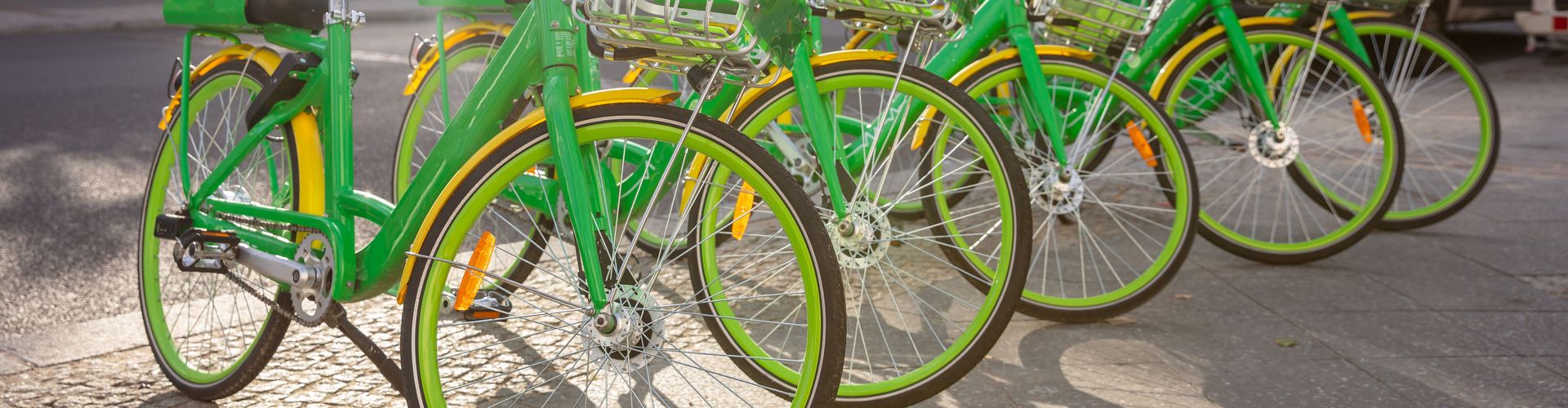 green-bikes-with-baskets-parked-on-a-cobblestone-Envato.jpg