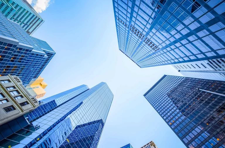 Skyscrapers with powder coated facades viewed from the ground up 